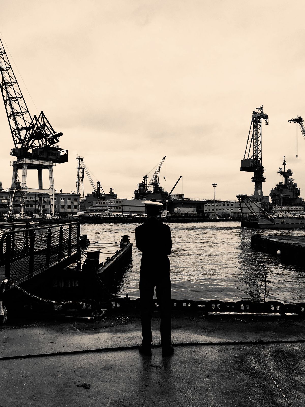 Port / logistics — tall port cranes and port industrial skyline, sepia tone